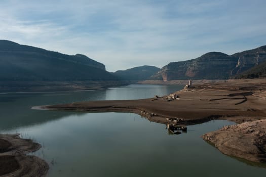 Aerial view dry and cracked earth in the reservoir at Sau reservoir, Catalonia