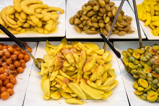 Sour and Spicy Mango at Thai Food Market on Wat Saket Festival Fair in Bangkok in Thailand.  Thailand, Bangkok, November, 8, 2024.