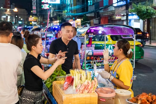 People and shops at Night Streetmarket on Yaowarat Road in Chinatown in City of Bangkok in Thailand.  Thailand, Bangkok, November, 4, 2024.