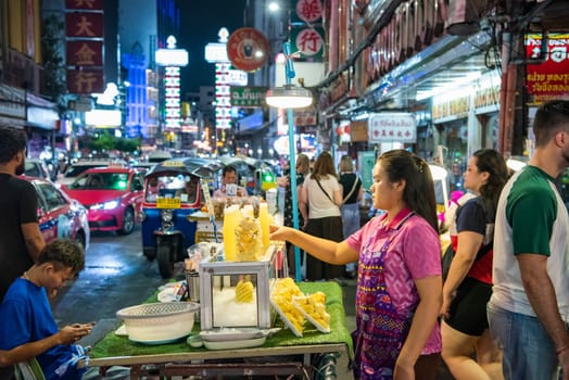 People and shops at Night Streetmarket on Yaowarat Road in Chinatown in City of Bangkok in Thailand.  Thailand, Bangkok, November, 4, 2024.