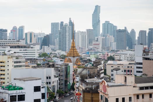 Wat Traimit in Chinatown with skyline in the City of Bangkok in Thailand.  Thailand, Bangkok, November, 5, 2024.