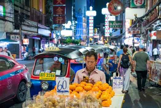 People and shops at Night Streetmarket on Yaowarat Road in Chinatown in City of Bangkok in Thailand.  Thailand, Bangkok, November, 4, 2024.