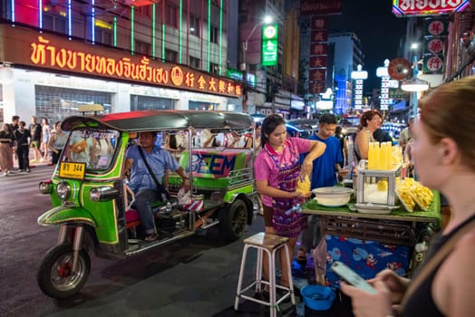 People and shops at Night Streetmarket on Yaowarat Road in Chinatown in City of Bangkok in Thailand.  Thailand, Bangkok, November, 4, 2024.
