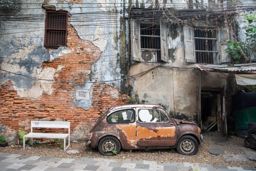 a old car in a alley in Talat Noi at China Town in City of Bangkok in Thailand.  Thailand, Bangkok, November, 5, 2024.