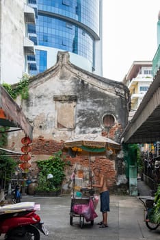 a old men on a grill in alley in Talat Noi at China Town in City of Bangkok in Thailand.  Thailand, Bangkok, November, 5, 2024.
