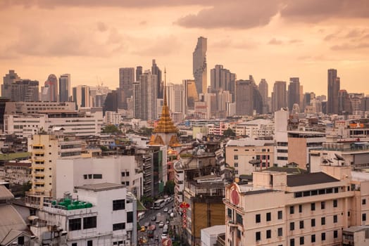 Wat Traimit in Chinatown with skyline in the City of Bangkok in Thailand.  Thailand, Bangkok, November, 5, 2024.