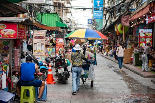 a Market street with shops in the China Town with skyline in the City of Bangkok in Thailand.  Thailand, Bangkok, November, 6, 2024.