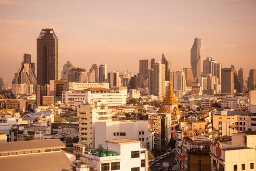 Wat Traimit in Chinatown with skyline in the City of Bangkok in Thailand.  Thailand, Bangkok, November, 6, 2024.