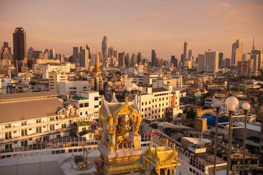 Wat Traimit in Chinatown with skyline in the City of Bangkok in Thailand.  Thailand, Bangkok, November, 6, 2024.