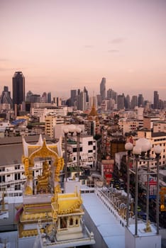 Wat Traimit in Chinatown with skyline in the City of Bangkok in Thailand.  Thailand, Bangkok, November, 6, 2024.