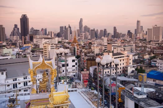Wat Traimit in Chinatown with skyline in the City of Bangkok in Thailand.  Thailand, Bangkok, November, 6, 2024.