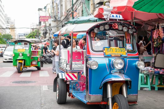a Tuk Tuk at Marketstreet on Yaowarat Road in Chinatown in City of Bangkok in Thailand.  Thailand, Bangkok, Dezember, 14, 2024.