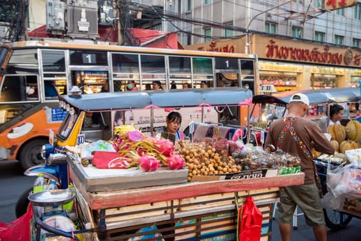 People and Tuk Tuk at Marketstreet on Yaowarat Road in Chinatown in City of Bangkok in Thailand.  Thailand, Bangkok, Dezember, 14, 2024.