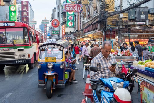 People and Tuk Tuk at Marketstreet on Yaowarat Road in Chinatown in City of Bangkok in Thailand.  Thailand, Bangkok, Dezember, 14, 2024.