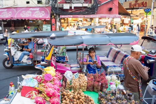 People and Tuk Tuk at Marketstreet on Yaowarat Road in Chinatown in City of Bangkok in Thailand.  Thailand, Bangkok, Dezember, 14, 2024.