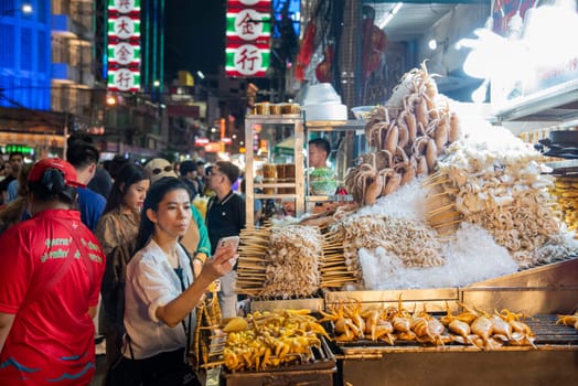 Seafood shops at Night Streetmarket on Yaowarat Road in Chinatown in City of Bangkok in Thailand.  Thailand, Bangkok, December,14, 2024.