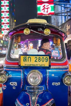 a Tuk Tuk at Marketstreet on Yaowarat Road in Chinatown in City of Bangkok in Thailand.  Thailand, Bangkok, Dezember, 14, 2024.