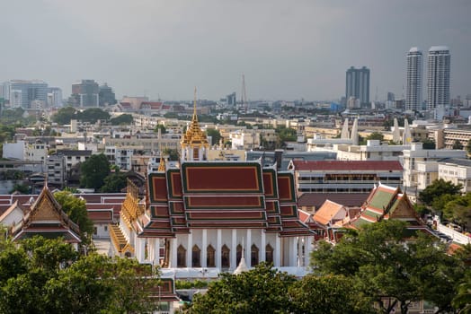 Wat Ratchanatdaram Worawihan with skyline in the City of Bangkok in Thailand.  Thailand, Bangkok, November, 7, 2024.
