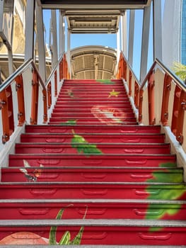Bangkok, Thailand - November 11, 2024: Creative urban street art of a tomato on a stairway, decorative abstract stairs in the Thai downtown district. Modern style graffiti design on steps.