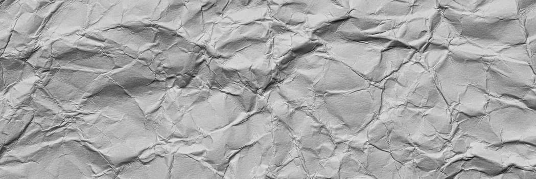 A textured light gray crumpled paper background with natural creases and folds. Ideal for design projects, digital graphics, or creative presentations requiring a vibrant, Long banner