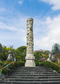 Singapore, Singapore - 4 April 2025: Granite Huabiao column with dragon carving in The Canyon, Gardens by the Bay, inspired by classical Chinese architecture