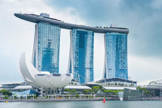 Singapore, Singapore - 4 April 2025: Iconic Marina Bay Sands hotel and ArtScience Museum under cloudy sky in Singapore. Modern architecture by the waterfront.