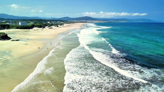 Experience the tranquil beauty of the beach and ocean in this aerial view capturing nature's essence.