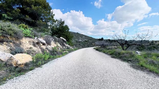 A beautiful and scenic path winding through lush, green hills under bright, sunny skies, perfect for nature lovers