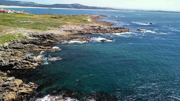Breathtaking, stunning views of rugged rocky coastlines meeting the clear, turquoise waters beneath a bright blue sky