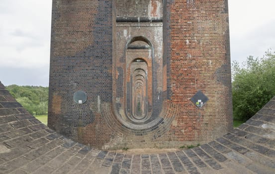 Sussex, UK - May 21, 2025 - Architectural splendour of Ouse Valley Viaduct or Balcombe Viaduct (Railway viaduct) has been described as “the most elegant viaduct in Britain” carries the Brighton Main Line over the River Ouse in Sussex. Semi-circular arches vaulting supporting traditional red brick piers topped with smooth limestone, use it as your Wallpaper, Poster and Copy space, Selective focus.