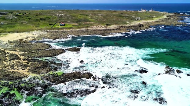 Enjoy stunning aerial views of a rocky coastline, clear turquoise waters, and a picturesque landscape