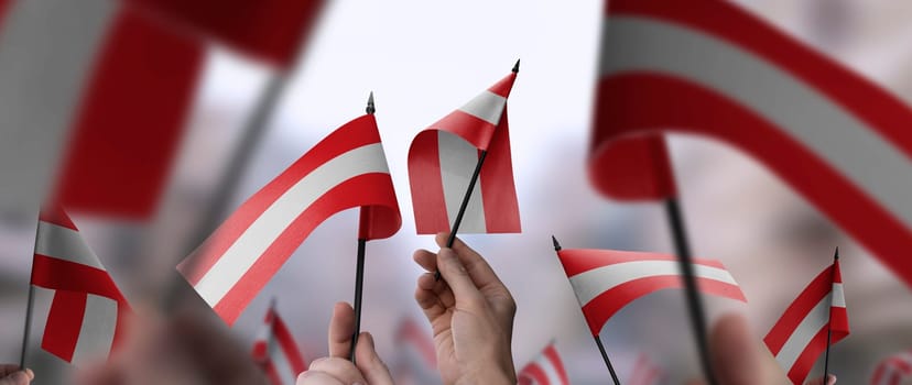 Austria flags in their hands on a blurred urban background. The photo illustration was created without the use of artificial intelligence, only using Photoshop.