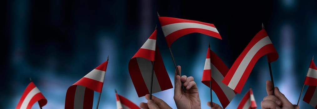 Austria flags in their hands on a blurred urban background. The photo illustration was created without the use of artificial intelligence, only using Photoshop.