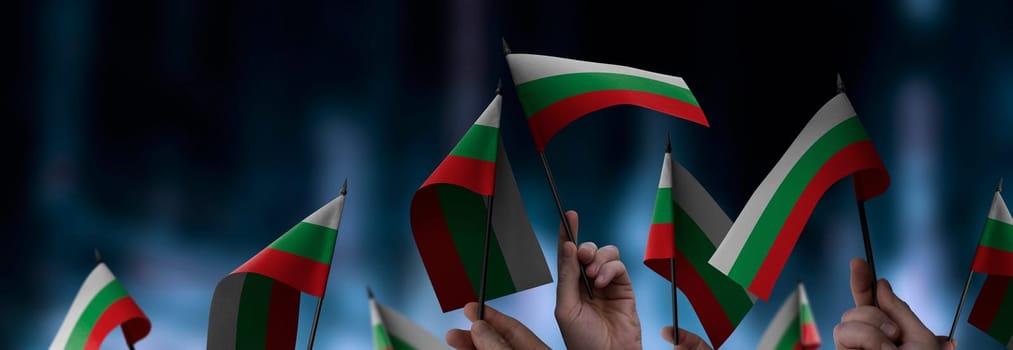 Bulgaria flags in their hands on a blurred urban background. The photo illustration was created without the use of artificial intelligence, only using Photoshop.