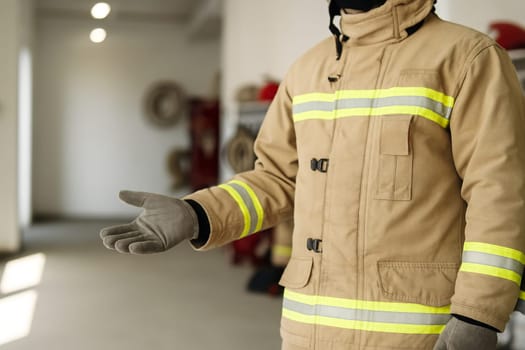 AI generated A professional firefighter in full gear stands at the frame edge gesturing welcomingly toward a well-equipped fire station The scene conveys emergency response teamwork and public safety