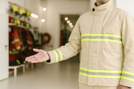 AI generated A professional firefighter in full gear stands at the frame edge gesturing welcomingly toward a well-equipped fire station The scene conveys emergency response teamwork and public safety