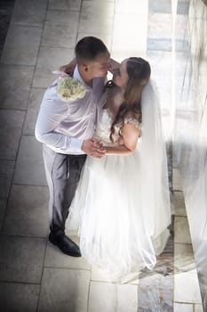 A bride and groom embrace lovingly, capturing their happiness during the wedding registration after their ceremony.