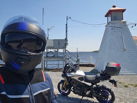 Experience a thrilling motorcycle ride along the coast, capturing the essence of freedom and adventure. A scenic journey with a biker and a lighthouse, perfect for summer exploration.