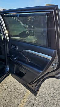 A detailed view inside a car showcasing the door panel with a sunshade, highlighting interior design and features. This image represents automotive comfort, style, and detail.