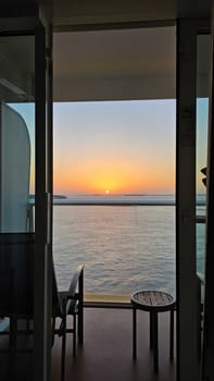 Enjoy a serene sunset ocean view from a cruise ship balcony. This tranquil scene embodies relaxation and travel, perfect for vacation marketing and inspiring wanderlust.