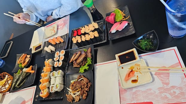 An exquisite display of sushi rolls and nigiri, showcasing vibrant colors and textures. A perfect representation of the artistry and deliciousness of Japanese cuisine.