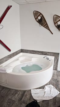 Indulge in relaxation with this cozy corner jacuzzi tub. Bubbles and warm water create a soothing atmosphere, enhanced by charming winter-themed decor. A perfect retreat for unwinding.