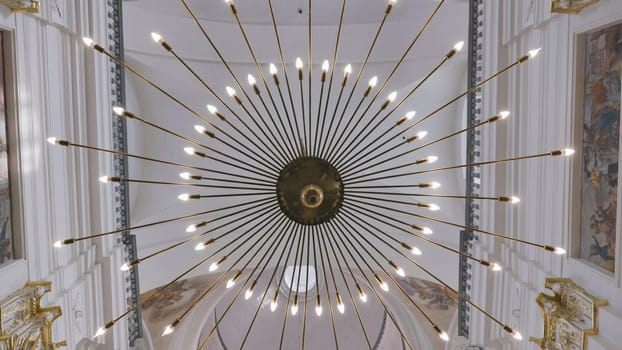 Beautiful ray-shaped chandelier in a Catholic church