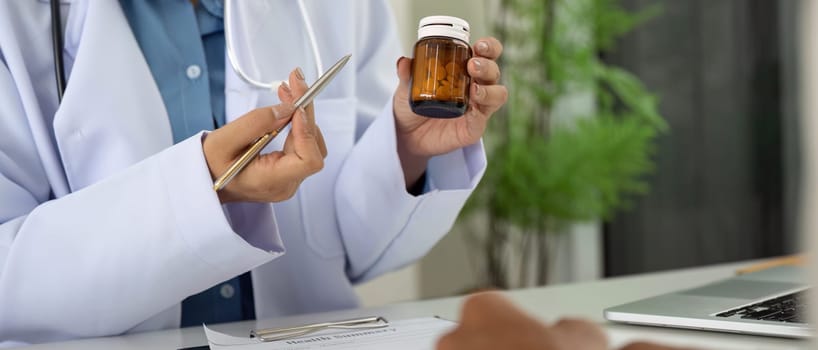 A healthcare provider discusses medication options while referencing a health summary during a patient consultation.