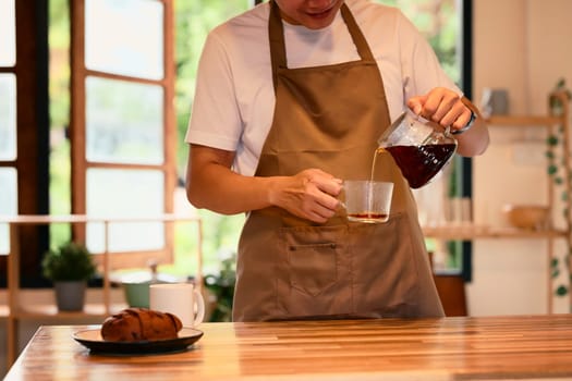 Morning routine with a man making handcrafted coffee in a relaxed home.