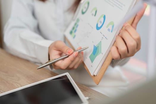 A business professional reviewing ESG metrics on a clipboard, emphasizing sustainability and corporate responsibility.