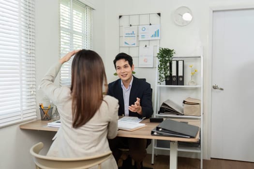 A business consultant explaining strategies to a client during a meeting, emphasizing personalized service and collaboration.