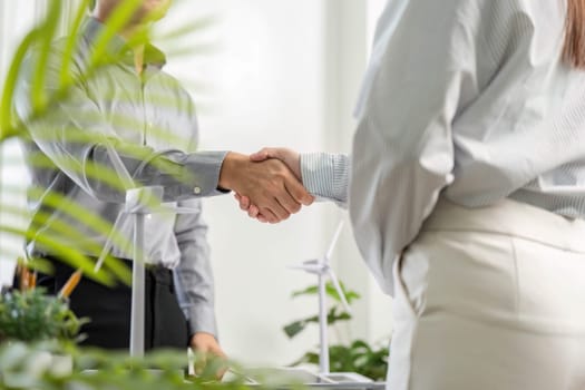 A handshake symbolizes a successful business partnership focused on ESG principles and sustainability.
