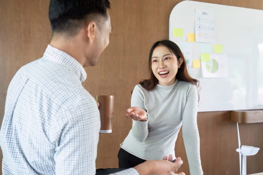 Professionals engage in a lively discussion about sustainable practices, fostering a positive work environment.