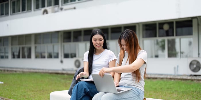 The engaging atmosphere of a university campus, where friends are seen diving into their homework with the help of modern technology, enhancing their academic performance.